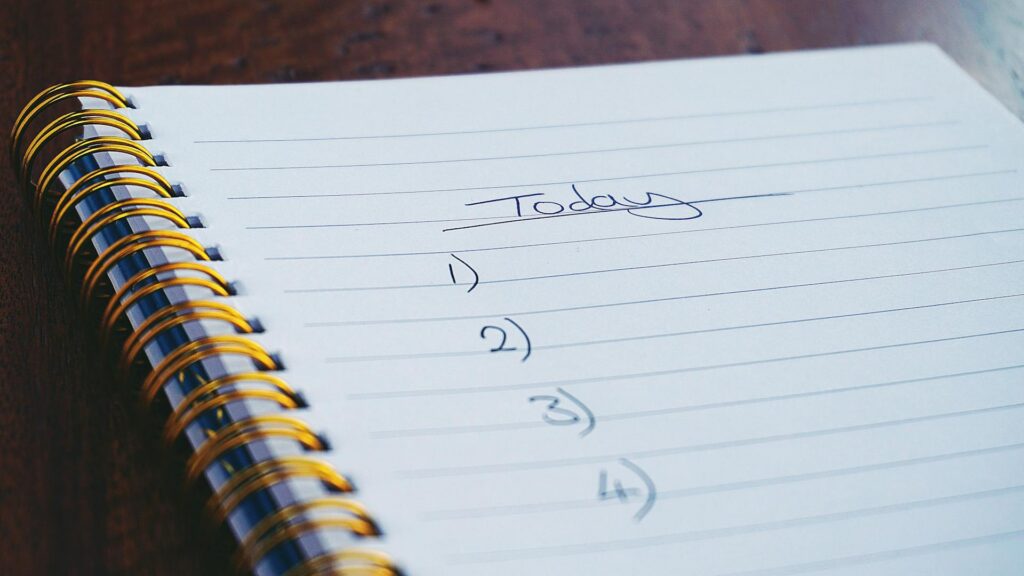 Notebook with pen on desk representing note-taking and information management for NotebookLM insights
