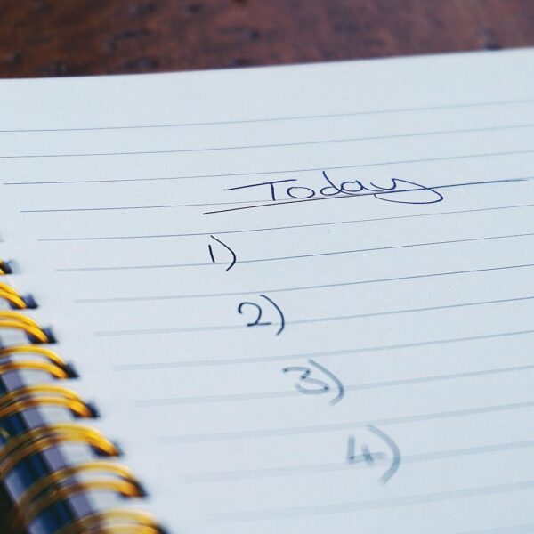 Notebook with pen on desk representing note-taking and information management for NotebookLM insights