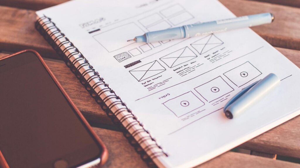 Organized workspace with notebook and planning materials representing modular thinking and productivity with Notion